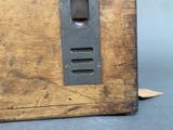 an old wooden box with a metal latch on it