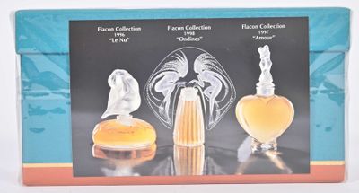 an image of a box with three perfume bottles and a glass figurine