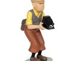statue of a man with a camera in his hand on a white background