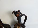 two vases that are sitting on a table