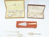 three silverware items including a knife, fork, spoon and spoon rest in a case