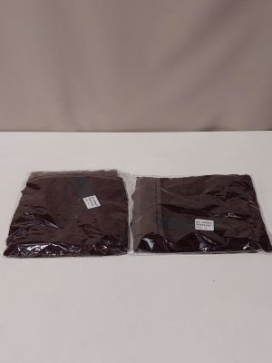 two bags of chocolate colored paper sitting on top of a white table