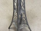 an image of a metal table with a glass top on a carpeted floor