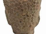 an image of a stone object on a stand on a white surface