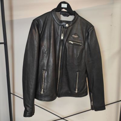 une veste en cuir noir suspendue à un cintre dans un magasin de vêtements