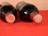 two bottles of wine that are sitting on a table