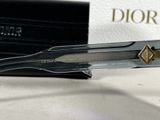 a pair of scissors sitting on a table next to a box