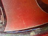 a close up of a red motorcycle with a smiley face on it