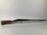 a rifle with a wooden barrel and a wooden handle