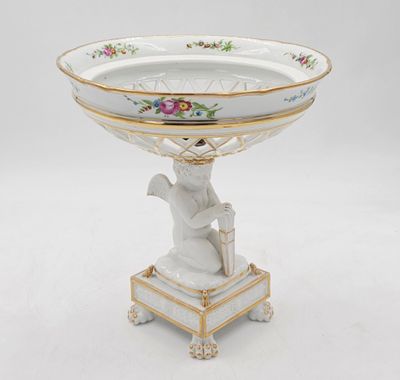 an image of a white and gold plate with a bird on it