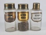 three glass jars with different types of spices in them
