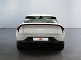 the rear end of a white car in a white room