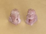 pair of pink jade figurines on a yellow background