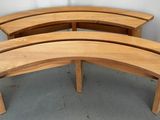 three wooden benches sitting next to each other in a room
