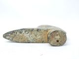 a stone object that is sitting on a white surface