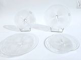 three clear glass plates with a clock on them sitting on a white surface