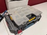 a tool box sitting on top of a table next to a pair of pliers