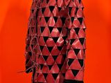 a red leather coat with black and white triangles on it