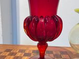 two vases sitting on a table next to each other