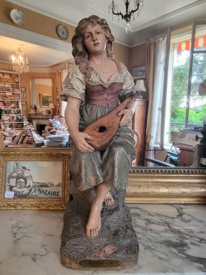 a statue of a woman holding a guitar in a living room