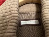 a close up of a sweater with a label on it