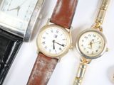 three different types of watches are displayed on a white surface