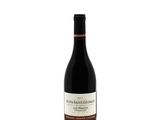 the bottle of wine is sitting on a white surface
