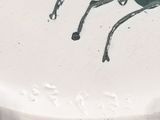a white plate with a black horse on it