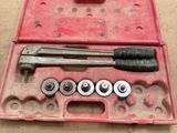 a tool box with a hammer, wrench, and other tools in it