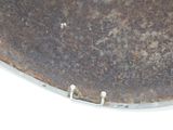 an old metal plate with a hole in the middle