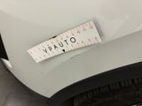 a measuring tape on the front of a white car