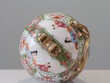 a white ball with a gold handle on a table