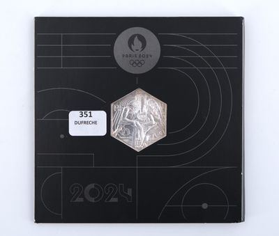 a picture of a silver coin with a picture of a man on it