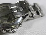 a close up of a watch on a white surface