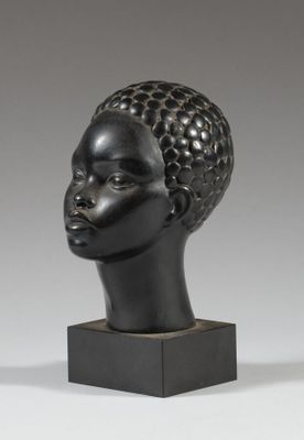 a black sculpture of a woman ' s head on a black base
