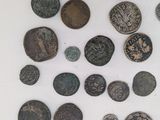 some of the ancient coins are arranged in a circle on a white surface