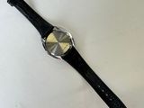 an image of a watch laying on top of a white surface