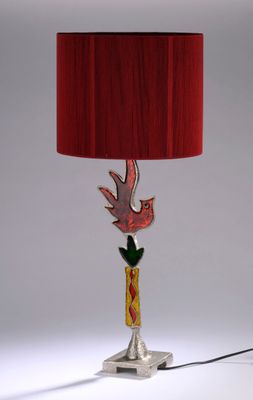 lamp with a red shade and a bird on the base