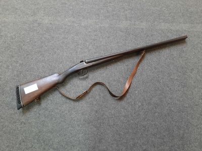 a rifle that is laying on the ground
