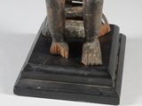 an image of a statue of a man sitting on top of a wooden block