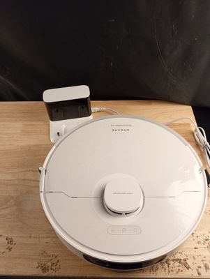 a white robot that is sitting on a wooden table