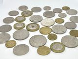 a pile of coins sitting on a white surface