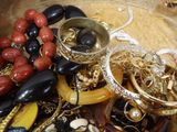 many different types of bracelets and rings on a table