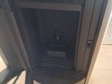 a black stove in the corner of a room