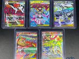 four different pokemon trading cards in plastic cases on a table