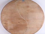 a wooden plate with a string on it on a white surface