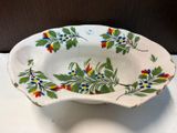 a white bowl with colorful flowers on it on a table