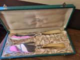 a box with a knife, spatula, and other items in it