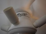 a close up view of a ceiling fan with a light on