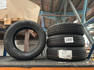 two tires are stacked on a shelf in a warehouse